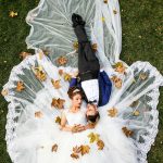 Aerial Photo of Man and Woman Lying on Grass Field